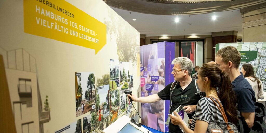 Menschen stehen vor einer Ausstellungswand von Oberbillwerder